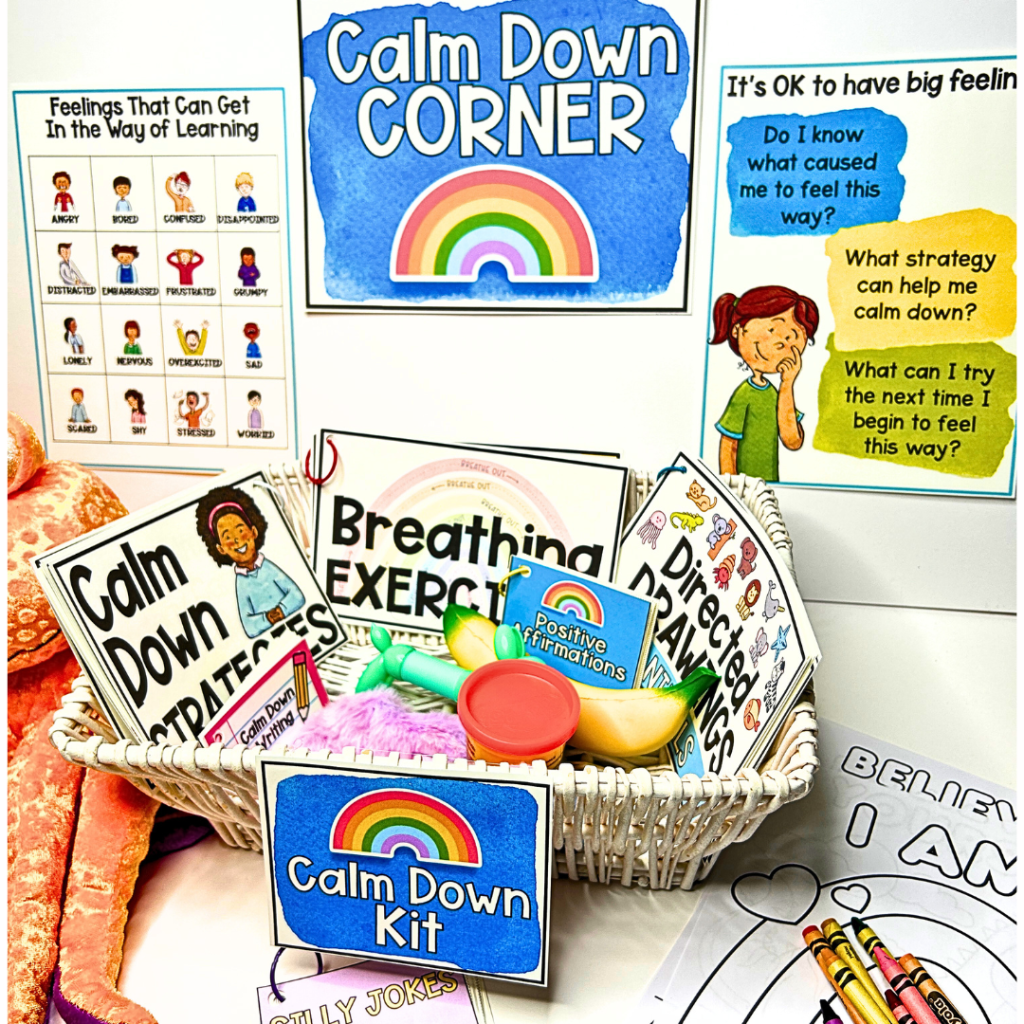 This image shows a calm down corner setup for a classroom, featuring a white basket filled with various tools and resources for emotional regulation. Items in the basket include cards labeled "Calm Down Strategies," "Breathing Exercises," "Positive Affirmations," "Directed Drawings," and "Silly Jokes," along with physical items such as Play-Doh and a squishy toy. Surrounding the basket are posters, including one titled "Feelings That Can Get in the Way of Learning," showing illustrations of different emotions, and another titled "It's OK to Have Big Feelings," with reflective questions to guide students in managing their emotions. A bright rainbow-themed "Calm Down Corner" sign is prominently displayed.