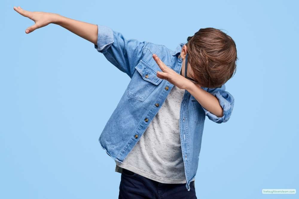 Upper elementary student striking a fun dance pose during a classroom talent show or end-of-year celebration activity.