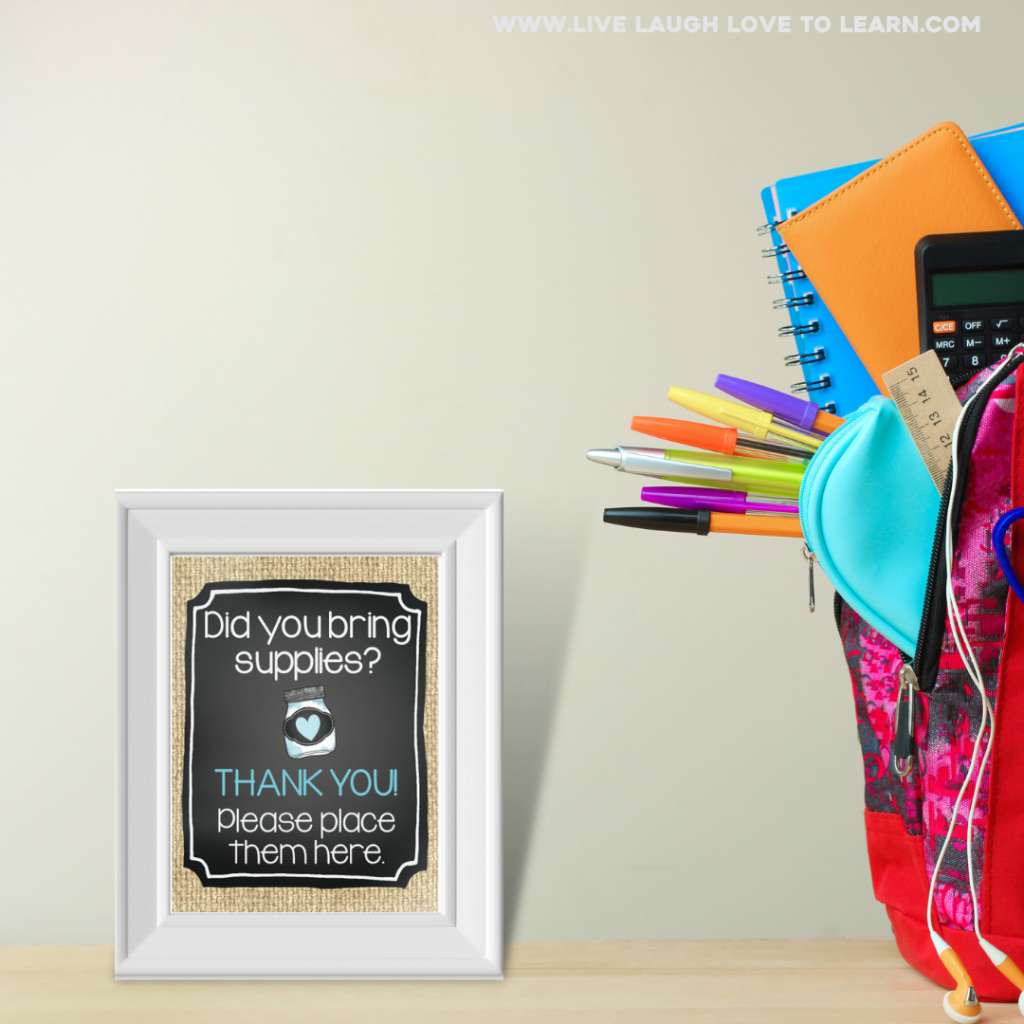 Image of frame on a table next to a backpack with earbuds, pens, ruler, calculator and notebooks sticking out of the side. Inside the frame the text reads "Did you bring supplies? Thank you! Please place them here."