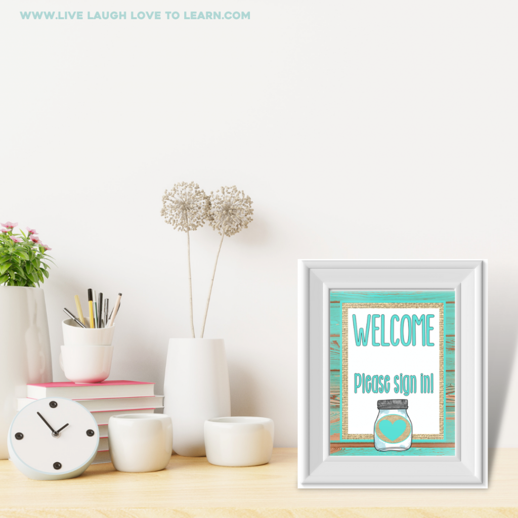 Image of frame on a table next to a vase with flowers, books, and a pencil cup. Inside the frame the text reads "Welcom. Please sign in."