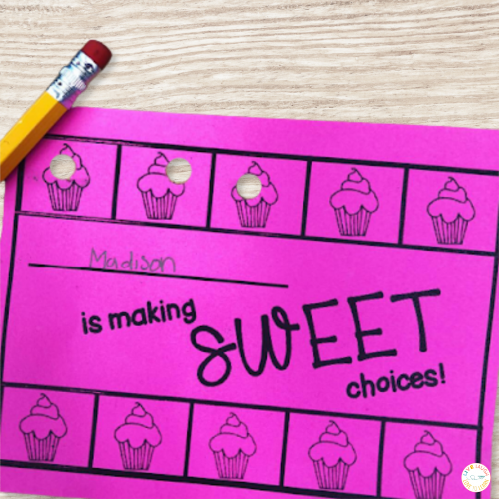 picture of a pink behavior punch card on a desk that reads "Madison is making SWEET choices!"