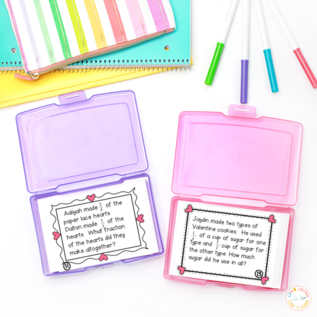 Image of Valentine's Day math task cards in task card box showing Valentine-themed fraction word problems. On a desk with notebooks and markers.