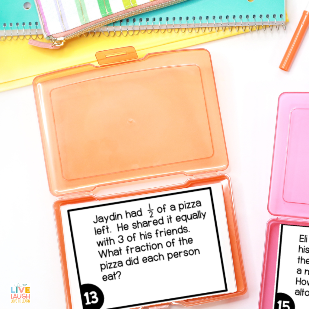 Image of a desk with notebooks and task card boxes. The task card shows a fraction word problem.