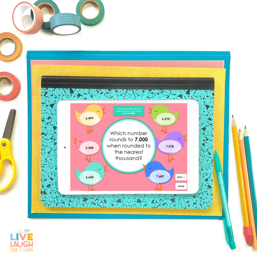 Image of a tablet on top of a composition book with pencils and pens along side. On the tablet is an image of colorful cartoon birds with numbers on them and a question "Which number rounds to 7,000 when rounded to the nearest thousand?"
