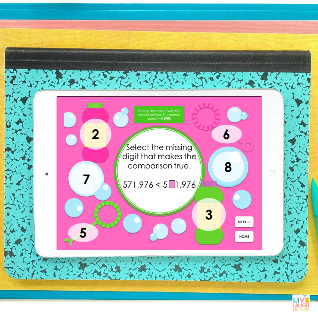 An image of a white tablet showing a screen of a digital bubbles place value game. The screen shows 6 different numbers in bubbles around the edge of the screen. The center of the screen reads "select the missing digit that makes the comparison true". Below that is an inequality with two numbers. One number has a pink square covering one of the digits. When the correct number is selected, the number and bubble will spin.