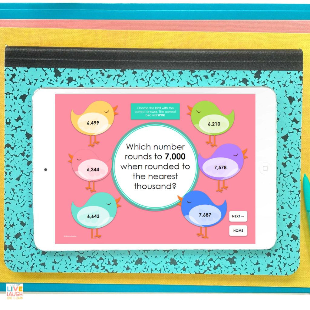 An image of a white tablet showing a screen of a digital birdie place value game. The screen shows 6 different numbers on birds around the edge of the screen. The center of the screen reads "which number rounds to 7,000 when rounded to the nearest thousand?". When the correct number is selected, the number and bird will spin.