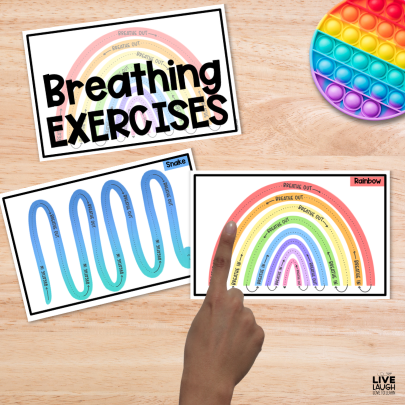 Image of breathing exercise cards on a table. A printed rainbow with directions to breathe in and breathe out with a child's finger on the rainbow.