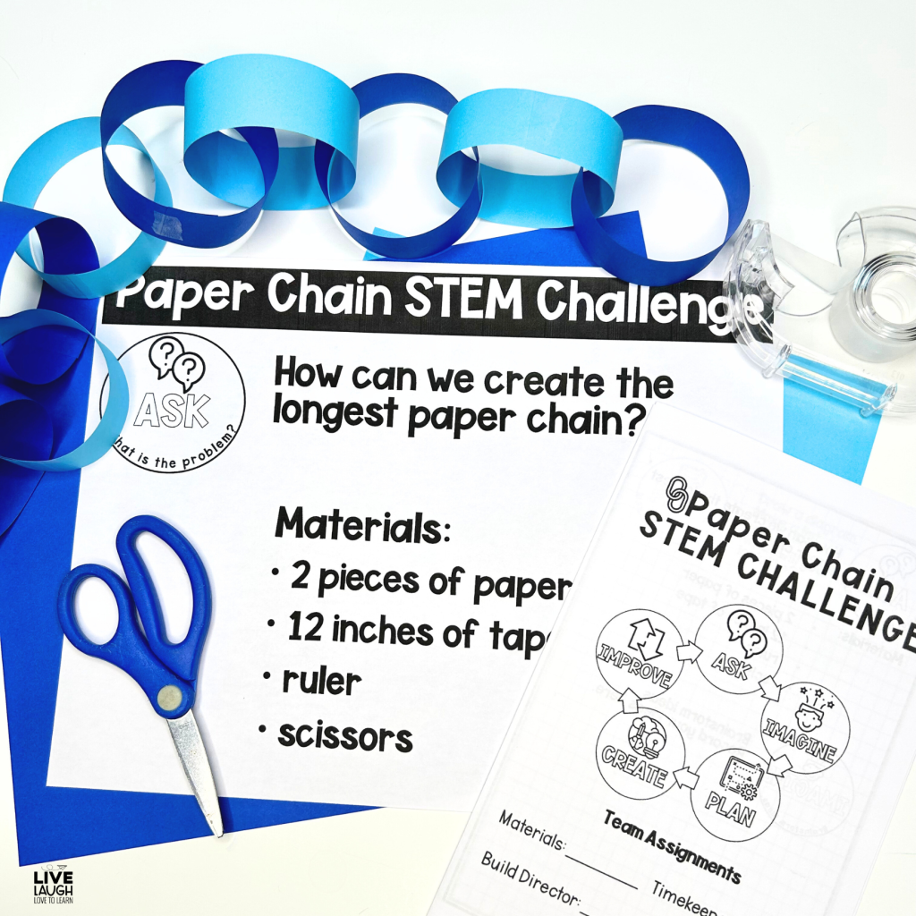 The image shows materials for a "Paper Chain STEM Challenge." It includes a task sheet that asks, "How can we create the longest paper chain?" The materials listed are two pieces of paper, 12 inches of tape, a ruler, and scissors. Surrounding the task sheet are blue paper strips formed into a chain, scissors, tape, and additional paper. Another sheet visible in the image outlines the STEM process with steps such as Ask, Imagine, Plan, Create, and Improve.