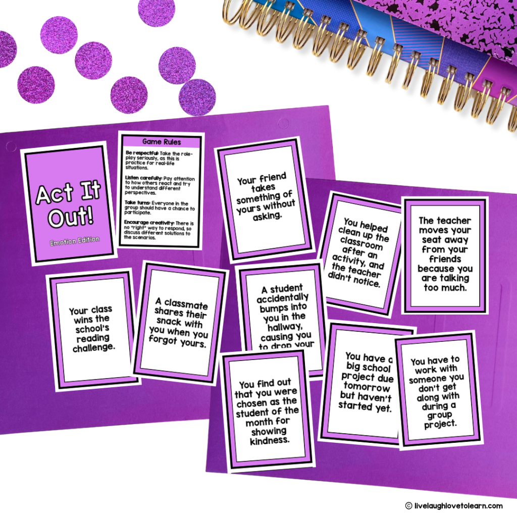Playing card-sized cards titled "Act It Out Emotion Edition," one labeled as a Game Rules and other cards feature scenarios like "Your friend takes something of yours without asking". The papers are on a desk with purple glitter dots and a colorful spiral notebook.