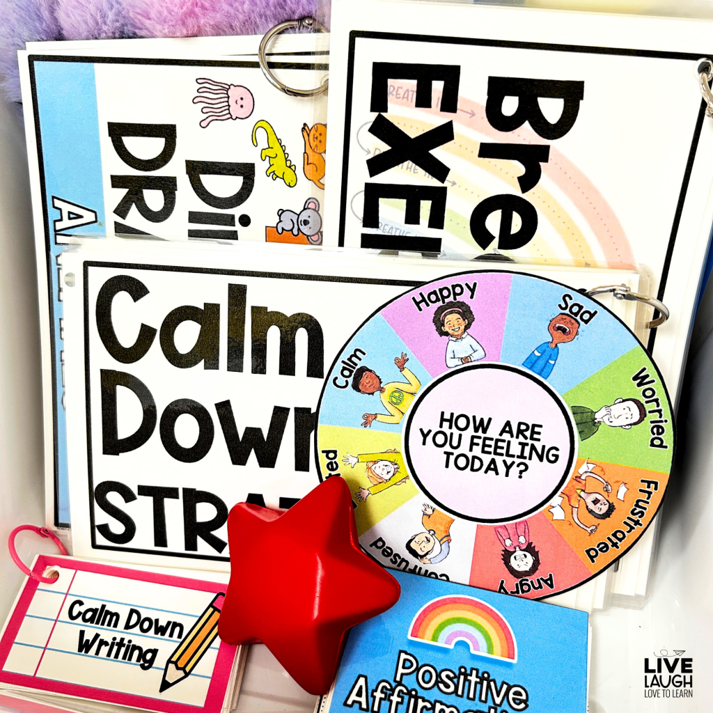 Here is an alt text description for this image:A close-up of a Calm Down Kit filled with emotional regulation tools, including a laminated emotions wheel labeled 'How Are You Feeling Today?' with colorful illustrations of different emotions. The kit also contains breathing exercises, directed drawing prompts, calm down strategies, a positive affirmations flipbook, and a calm down writing activity. A red star-shaped stress ball is placed in front, offering a tactile calming tool for students. The variety of resources provides multiple ways for students to manage their emotions effectively.