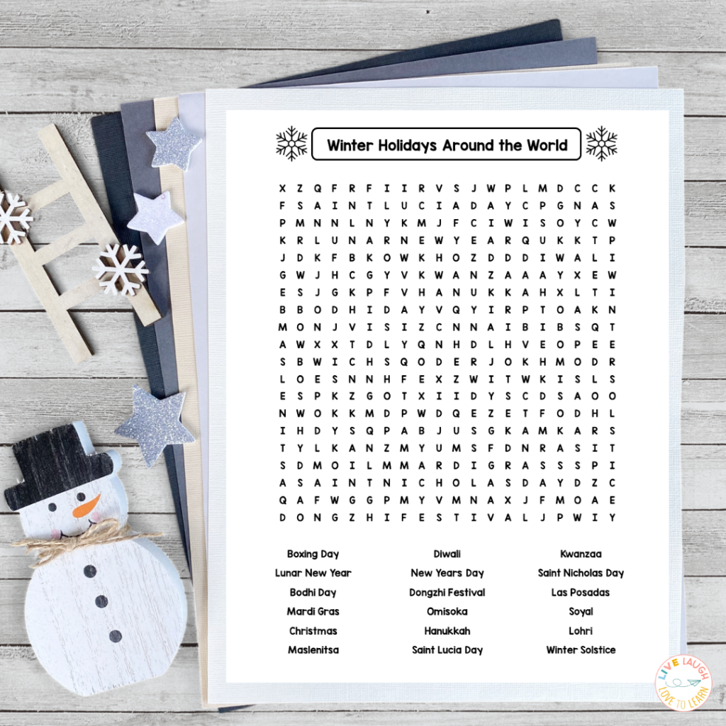 A free printable Winter Holidays Around the World word search worksheet featuring holiday names such as Diwali, Hanukkah, Kwanzaa, and Christmas. The page is styled with snowflake icons and displayed on layered pastel papers with wooden snowflake and star decorations, perfect for holidays around the world activities in the classroom.