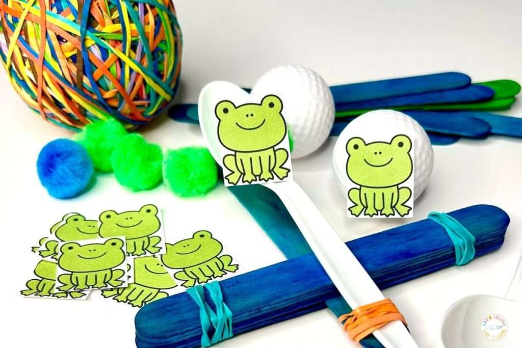 Hands-on materials for an elementary SEL in STEM Leap Frog Catapult activity teaching teamwork and conflict resolution using frog cutouts, craft sticks, spoons, and rubber bands