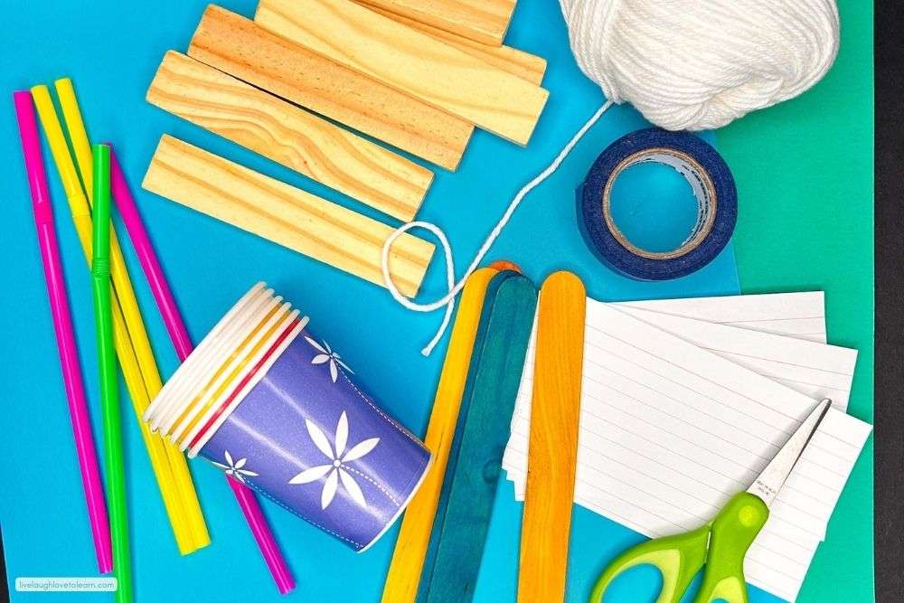 Materials used for the Voices Matter STEM challenge, including craft sticks, string, tape, paper cups, and classroom supplies.