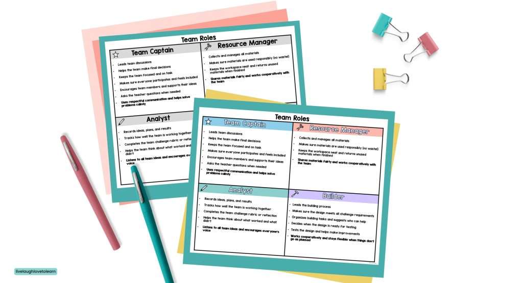 Color and black-and-white STEM Team Roles cards on a desk with pens and clips, featuring Team Captain, Resource Manager, Analyst, and Builder roles
