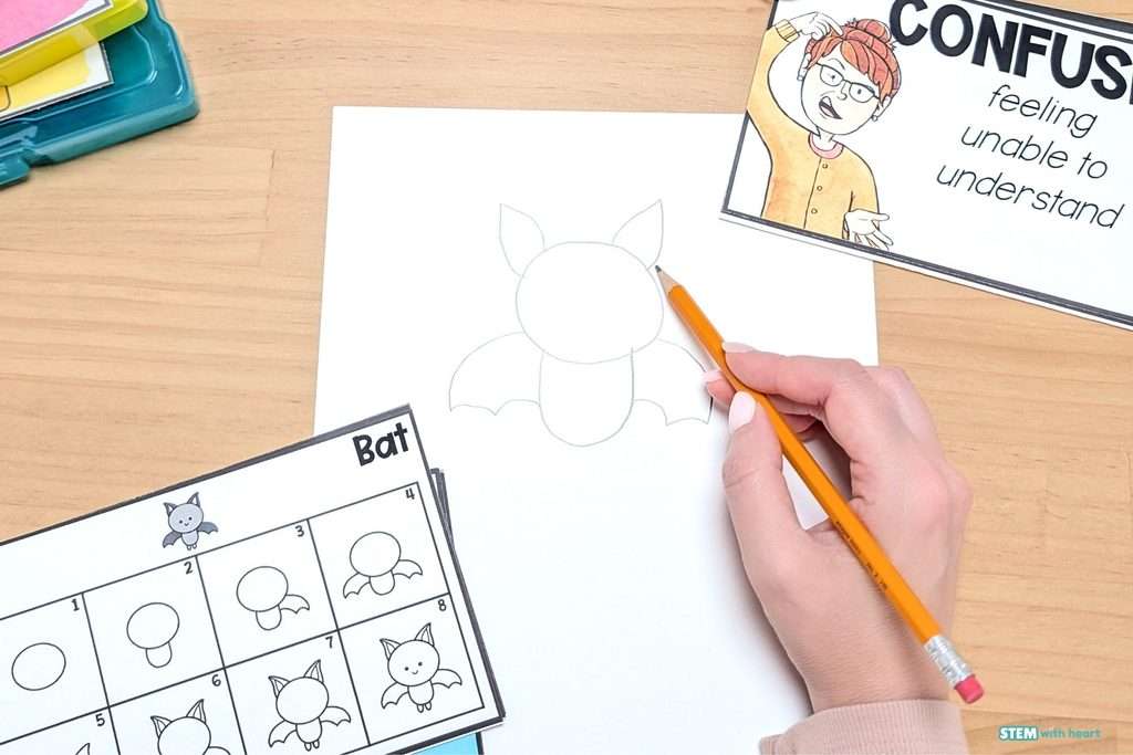 Student using a directed drawing activity as a calming strategy in a classroom calm down corner.